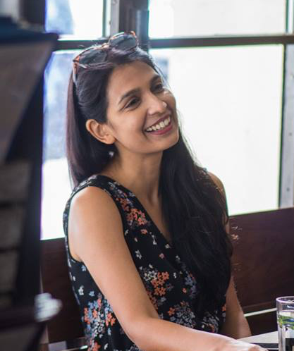 Female Founder Sonali Nigam sitting at a coffee shop